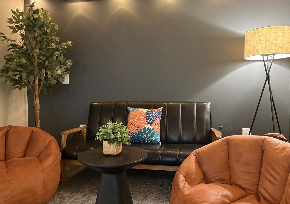 The cozy student lounge with a leather couch and beanbag chairs